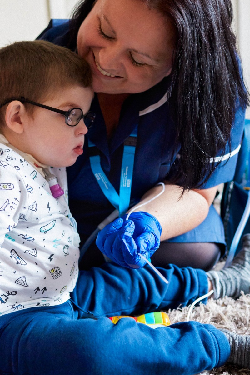 A nurse talks with a child during treatment