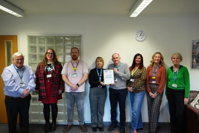 Neil Carr, Chief Executive, stands with members of the teams involved in the national accreditation.
