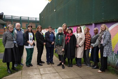 Image shows the Arts for Health team with colleagues at the mural.
