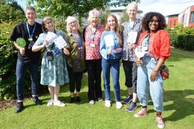 Arts for Health Team stand with artists